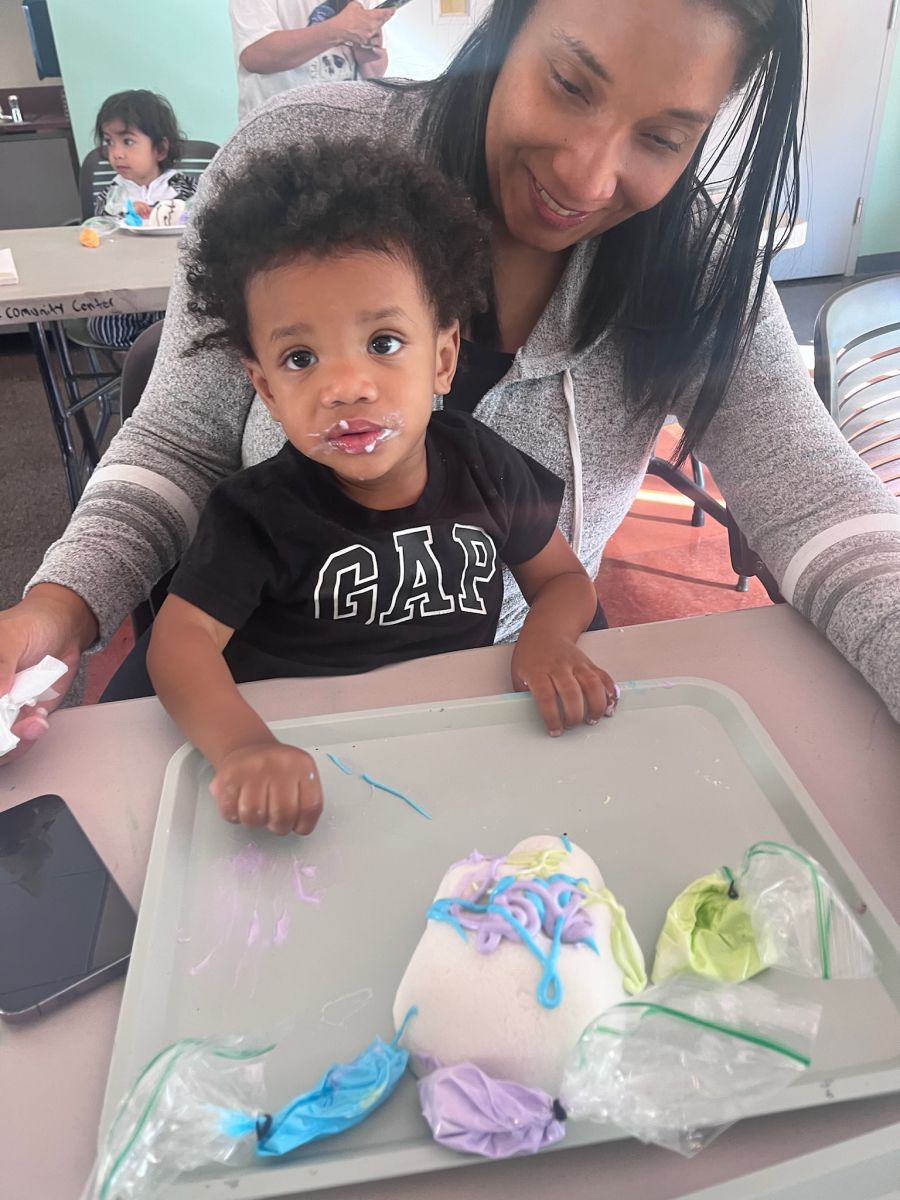Little boy and therapist playing with cake